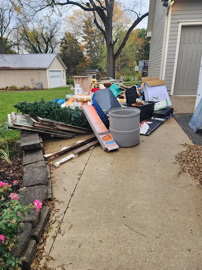 Dumpster being loaded with debris for 10 Yard Dumpster Rental in Waggaman